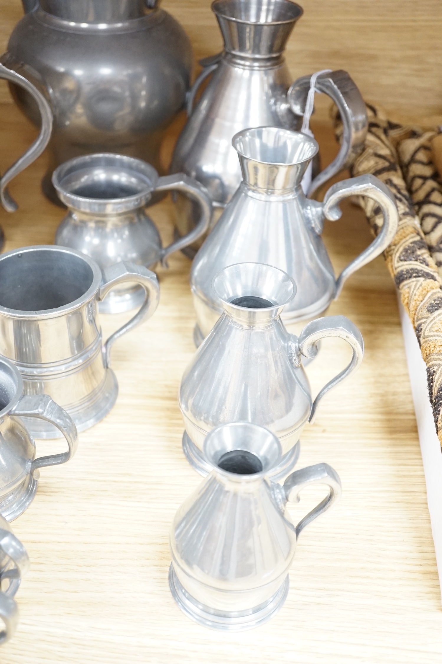 A collection of 19th/20th century pewter jugs, mugs and flagons (15), large jug 20cm high